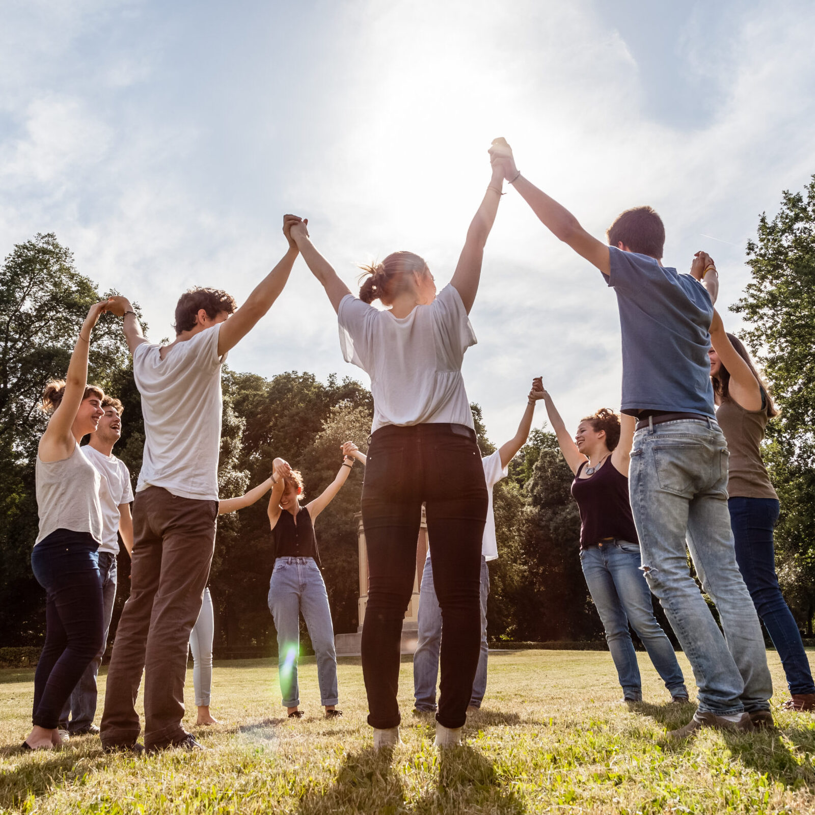 Group of friends at the park holding hands